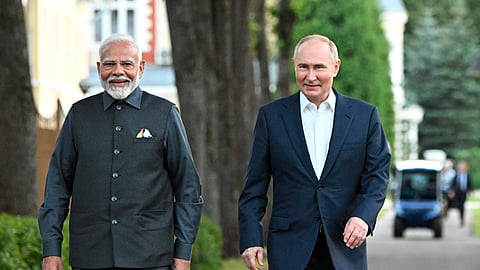 ndian Prime Minister Narendra Modi, left, and Russian President Vladimir Putin walk during an informal meeting at Novo-Ogaryovo residence, outside Moscow, Russia.