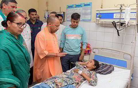 Uttar Pradesh Chief Minister Yogi Adityanath meets a woman injured in the Hathras stampede, in Hathras, Wednesday, July 3, 2024.