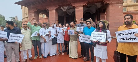 MPs protest against the Union Budget outside the parliament on Wednesday.