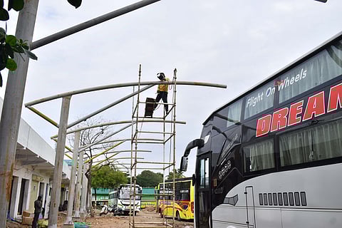 Worker engaged in welding work at Omni bus stand at Gandhipuram in Coimbatore on Tuesday.