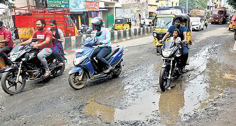 Vehicles navigate through Royapuram main road, which has turned slushy after recent spells of rain