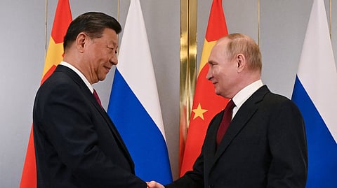 Russian President Vladimir Putin, right, and Chinese President Xi Jinping shake hands during their meeting on the sidelines of the Shanghai Cooperation Organisation (SCO) summit in Astana, Kazakhstan, July 3, 2024.