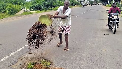 Vadluri Durgaiaha aka Auto Durgaiah fills potholes with gravel in Choppadandi mandal headquarters in Karimnagar district.