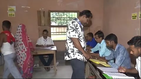 People cast their votes at a polling booth in Raiganj as polling underway for the Raiganj Assembly bypoll in West Bengal on Wednesday.