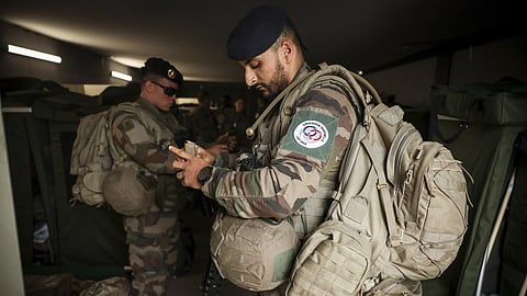Soldiers prepare for a patrol at the military camp set up in the Vincennes woods, Monday, July 15, 2024 just outside Paris.