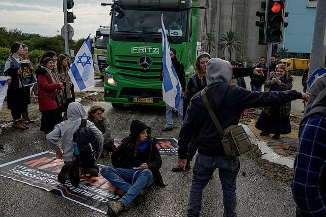 Israeli activists block the exit of Ashdod port to stop trucks they claim are carrying humanitarian aid to the Gaza Strip, in Ashdod, Israel