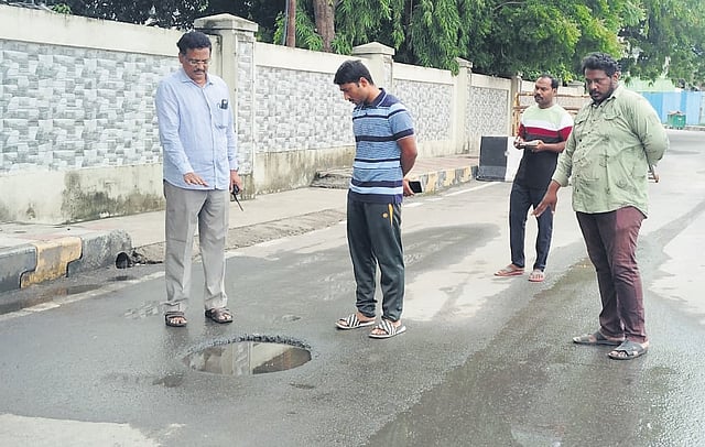 VMC In-Charge Commissioner A Mahesh inspecting a manhole near the Raj Bhavan on Monday Prasant Madugula 