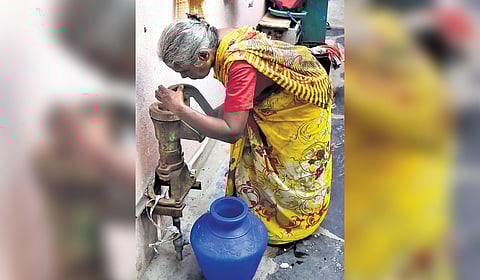 A women checking the water pump in Ezhil nagar in Chennai 