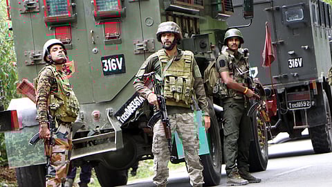 Army personnel stand guard at the encounter site where a jawan was killed in a gunfight with terrorists, in Kulgam on Saturday. 