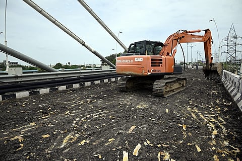 Roads and Buildings authorities removing BT layer on the Cable stayed bridge which was constructed about one year back across the Manair River on the outskirts of Karimnagar city