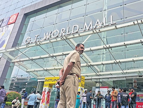 A police officer keeps vigil during an inspection of the GT World Mall premises by BBMP officials in Bengaluru 