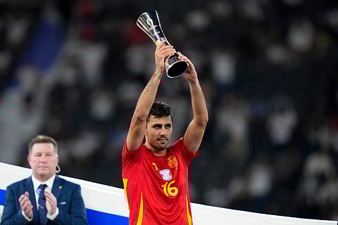 Spain's Rodri holds up the Best Player of the tournament trophy after the final match between Spain and England at the Euro 2024 football tournament