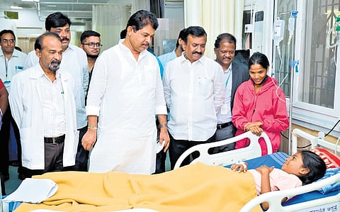 Leader of Opposition in the Assembly R Ashoka speaks to a patient, during an inspection of dengue preparedness, at KC General Hospital in Bengaluru on Sunday