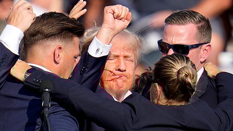 Republican presidential candidate former President Donald Trump is helped off the stage by U.S. Secret Service agents at a campaign event in Butler.