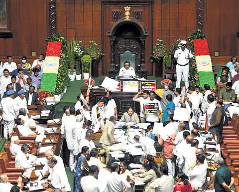 Opposition MLAs protest in the well of the Assembly on Wednesday
