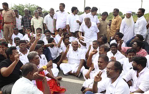 Former Minister RB Udhayakumar with various associations members stage a protest seeking to close the Kappalur toll plaza near Thirumangalam near Madurai on Tuesday