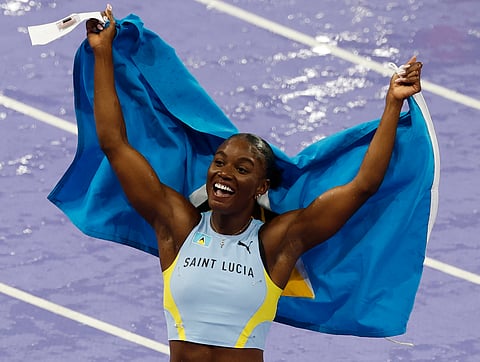 St Lucia's Julien Alfred celebrates after winning the women's 100m final of the athletics event at the Paris 2024 Olympic Games at Stade de France in Saint-Denis, north of Paris, on August 3, 2024.