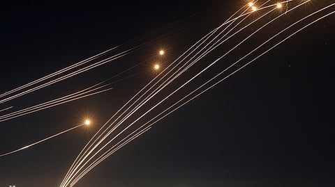 Rockets fired from southern Lebanon are intercepted by Israel's Iron Dome air defence system over the Upper Galilee region in northern Israel, on August 4, 2024, amid ongoing cross-border clashes between Israeli troops and Lebanon's Hezbollah fighters.