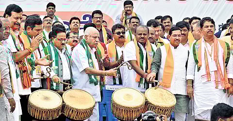 Senior BJP leader BS Yediyurappa with Union Ministers HD Kumaraswamy and Pralhad Joshi