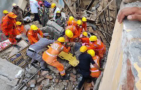 NDRF personnel carry out rescue work after two houses collapsed near the Kashi Vishwanath temple, in Varanasi, Tuesday, Aug. 6, 2024. A woman died in the mishap.