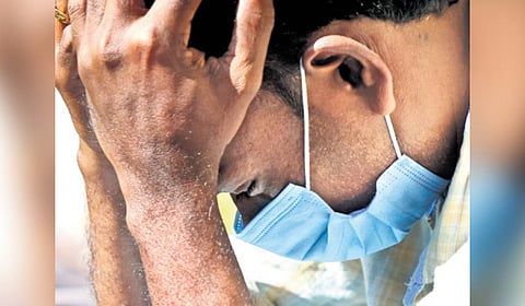 Chooralmala resident Brezhnev waits in front of the MSM Hall in Meppadi, where the bodies of landslide victims are kept for identification, on Sunday 