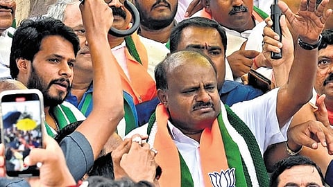 Nikhil Kumaraswamy with his father HD Kumaraswamy at the padayatra on Saturday.