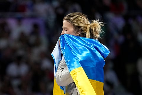 Ukraine's Olga Kharlan celebrates after winning the women's team sabre final match against South Korea during the 2024 Summer Olympics at the Grand Palais.