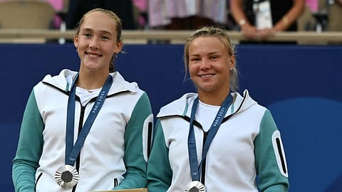 Silver medallists, Mirra Andreeva and Diana Shnaider pose with their medals on the podium at the presentation ceremony for the women's doubles tennis event during the Paris 2024 Olympic Games, in Paris on August 4, 2024.