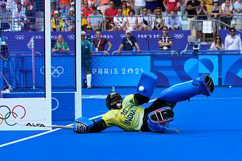 India's goalkeeper PR Sreejesh saves a shot by Britain's Phil Roper in the shoot-out during the men's quarterfinal at the Yves-du-Manoir Stadium  