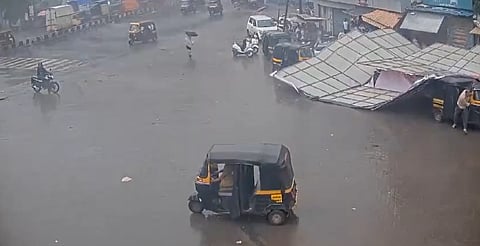 The hoarding came crashing down on three vehicles parked below it.
