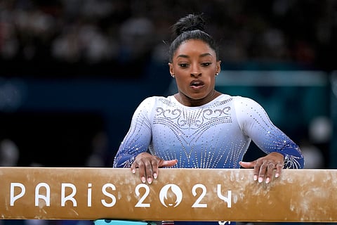 Simone Biles, of the United States, pauses after falling during the women's artistic gymnastics individual balance beam finals at Bercy Arena at the 2024 Summer Olympics.