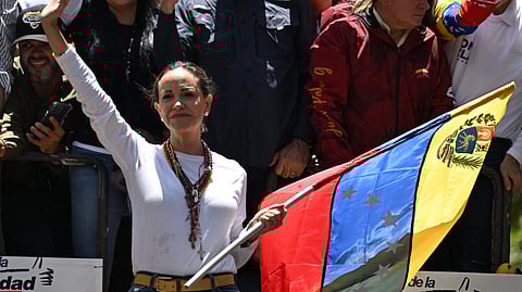 Venezuelan opposition leader Maria Corina Machado waves from atop a truck during a demonstration to protest over the presidential election results, in Caracas on August 3, 2024. 