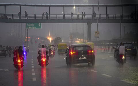 Vehicles ply on a road during rain, in New Delhi, Wednesday, July 31, 2024.