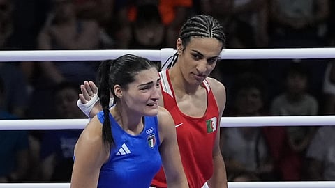 Algeria's Imane Khelif, red, next to Italy's Angela Carini, at the end of their women's 66kg preliminary boxing match at the 2024 Summer Olympics, Thursday, August 1, 2024 in Paris, France.
