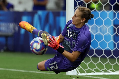 Germany's goalkeeper Ann-Katrin Berger stops the ball during the penalty shootout in the women's quarter-final football match between Canada and Germany during the Paris 2024 Olympic Games on August 3, 2024. 