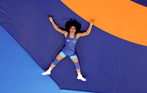 India's Vinesh Phogat (R) reacts her win over Cuba's Yusneylis Guzman Lopez (L) in their women's freestyle 50kg wrestling semi-final match at the Champ-de-Mars Arena during the Paris 2024 Olympic Games, in Paris on August 6, 2024.