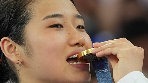 South Korea's An Se-young celebrates on the podium after wining the gold medal at the badminton women singles at the 2024 Summer Olympics