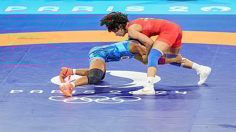 India's Vinesh Phogat (in red) and Cuba's Yusneylys Guzman Lopez compete in the Women's Freestyle 50kg semi-final wrestling match at the 2024 Summer Olympics, in Paris, France, Tuesday, Aug. 6, 2024.