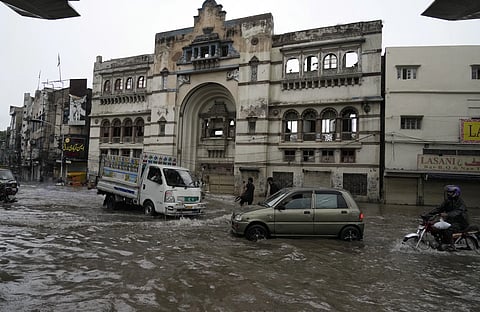 Motorcyclists and cars drive through a flooded road caused by heavy monsoon rainfall in Lahore, Pakistan, Thursday, August 1, 2024.