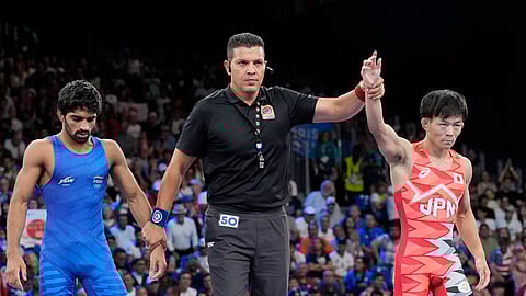 Japan's Rei Higuchi celebrates after defeating India's Aman Aman in their men's freestyle 57kg semifinal wrestling match, at Champ-de-Mars Arena, during the 2024 Summer Olympics, Thursday, Aug. 8, 2024, in Paris, France.