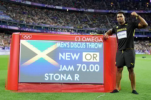 Roje Stona, of Jamaica, celebrates after winning the men's discus throw final at the 2024 Summer Olympics, Wednesday, Aug. 7, 2024, in Saint-Denis, France.