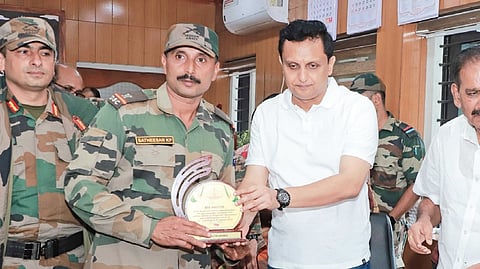 Minister P A Mohamed Riyas hands over a memento to an Army officer 