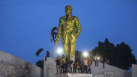 Protesters try to demolish a large statue of Sheikh Mujibur Rahman in Dhaka, Bangladesh, on Monday, Aug. 5, 2024.
