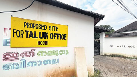 The state government has placed a board indicating the site of the proposed  taluk office on the revenue land portion of Aspinwall House