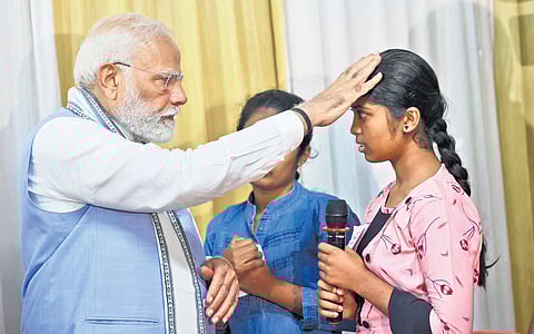 Modi interacts with inmates at a relief camp in Meppadi 