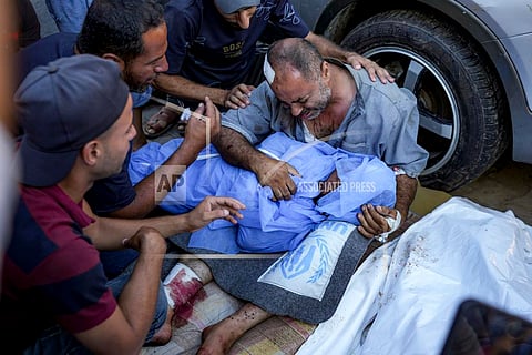 A Palestinian man mourns for a child killed in the Israeli bombardment of the Gaza Strip, at a hospital in Deir al-Balah, Saturday, Aug. 10, 2024.