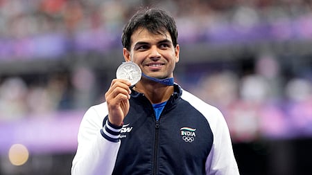Men's javelin silver medalist, Neeraj Chopra,  stands on the podium at the 2024 Summer Olympics, Friday, Aug. 9, 2024, 