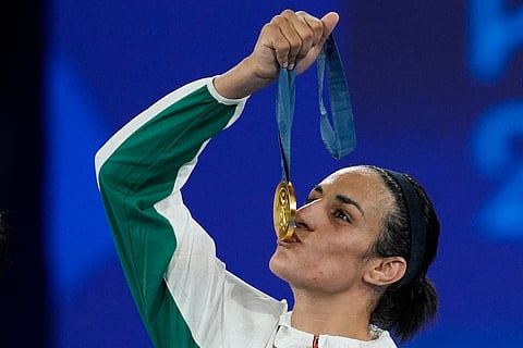Gold medalist Algeria's Imane Khelif kisses her medal for the women's 66 kg final boxing match at the 2024 Summer Olympics, Friday, Aug. 9, 2024, in Paris, France.