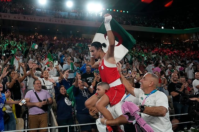 Algeria's Imane Khelif celebrates after defeating China's Yang Liu to win gold in their women's 66 kg final boxing match at the 2024 Summer Olympics, Friday, Aug. 9, 2024, in Paris, France.