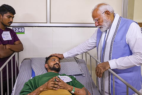 Prime Minister Narendra Modi interacts with a patient affected by the recent landslide, at AWS Hospital in Wayanad, Saturday, Aug. 10, 2024.
